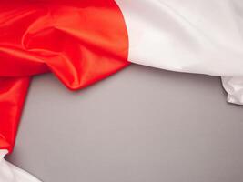 Top view of the Japan flag on a gray background with space for text photo