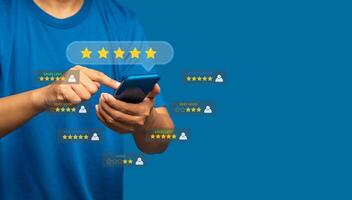 A customer using a smartphone gives the five-star icon a rating of very impressed for service while standing on a blue background photo