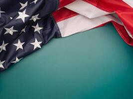 Top view of the American flag on a green background with copy space for text photo