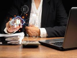 Data encryption security. A businesswoman login to cloud computing on a virtual screen while sitting in the office photo