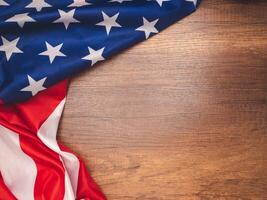 Top view of the American flag on a wooden table with copy space for text photo