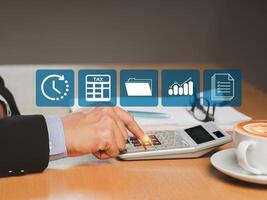 Tax day concept. A businessman uses a calculator to calculate taxes while sitting in the office photo