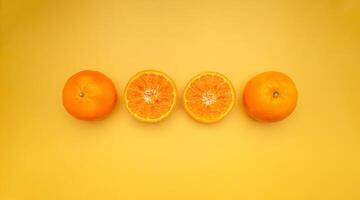 Top view of oranges is on a yellow background photo