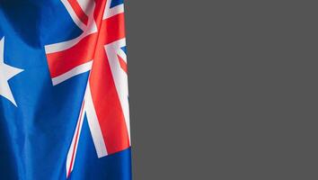 Close-up of the Australian flag is on the left side on a gray background photo