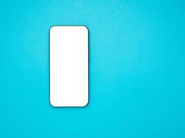 Top view mockup smartphone with a blank white screen on a light blue background photo