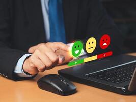 Positive feedback concept. Choosing a green happy mood icon rating review in the survey, poll, or customer satisfaction research on a virtual screen photo