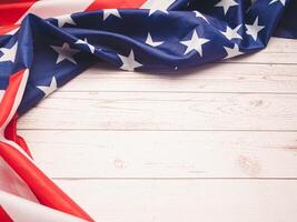 Top view of the American flag on a wooden table with copy space for text photo