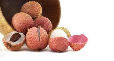 Fresh Lychee Fruits in a Wooden Bowl on a White Background photo