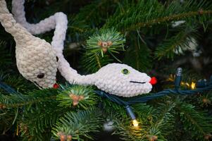 Handmade Plush Snake Ornaments on a Decorated Christmas Tree photo