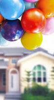 Colorful balloons with house blurred on background , vertical banner with copy space for text decoration photo
