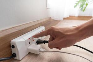 Man is turning off the light switch after not using it, energy saving, saving money, environmental conservation, reducing global warming, power photo