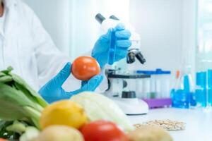 Scientist check chemical food residues in laboratory. Control experts inspect quality of fruits, vegetables. lab, hazards, ROHs, find prohibited substances, contaminate, Microscope, Microbiologist photo