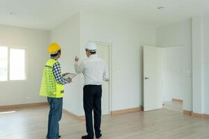 inspector engineer and owner project is inspecting construction and quality assurance new house. Engineers or architects or contactor work to build the house before handing it over to the homeowner photo