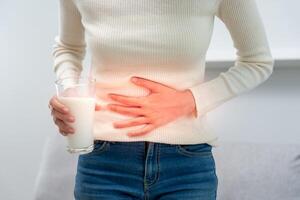 Milk allergens, Sick sad unhealthy ill allergic woman, runny stuffy sore nose suffer from intolerance allergy trigger symptoms. abdominal pain, allergens, nut protein, rash, death, food allergy photo