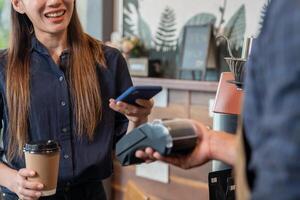 Woman use smartphone to scan QR code for order menu in cafe restaurant with a digital delivery. Choose menu and order accumulate discount. E wallet, technology, pay online, credit card, bank app. photo