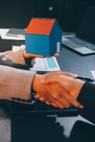 Close up Business people or Real Estate agent explain signing agreement for sale house to client. Property, Insurance, Broker concept. photo