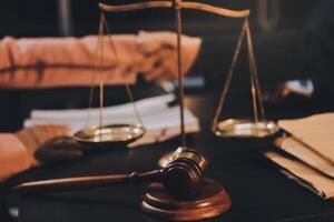 Judge gavel with Justice lawyers having team meeting at law firm background. Concepts of Law and Legal services. photo