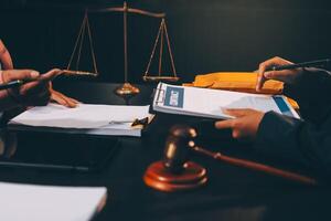 Judge gavel with Justice lawyers having team meeting at law firm background. Concepts of Law and Legal services. photo