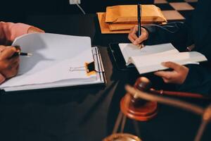 Judge gavel with Justice lawyers having team meeting at law firm background. Concepts of Law and Legal services. photo