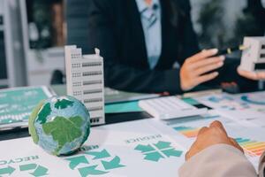 Carbon offset price report CO2 emission. Future growth Net zero waste in ESG ethical SME office protect climate change global warming social issues project. Group of asia people Eco friendly SDGs plan photo