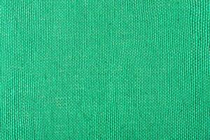 Green fabric background macro photo horizontal frame.