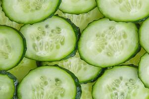 Cucumber slices as background. Vegetables cucumbers. photo