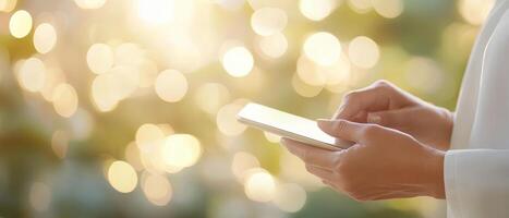 person using smartphone in bright, blurred background with bokeh lights creates serene atmosphere. image captures modern technology and tranquility photo