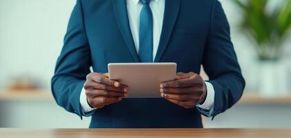 professional man in suit holding tablet in modern office setting, exuding confidence and focus. background features greenery, enhancing vibrant atmosphere photo
