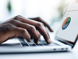financial consultant working on laptop, focusing on hands typing with pie charts displayed on screen. background is softly blurred for privacy, creating professional atmosphere photo
