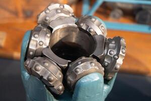 Drill bits. Perforator button for water wells. Tricone bit. Equipment for water and coal wells. Drilling photo