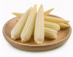 Baby corn, isolated on a white background, shows its small and slender shape. photo