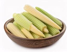 Baby corn, isolated on a white background, shows its small and slender shape. photo