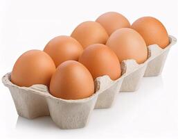 Ten chicken eggs lying in a paper box, isolated on a white background photo