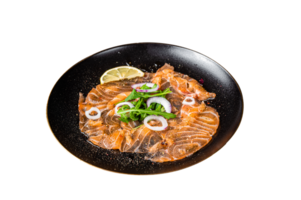 Fresh Salmon carpaccio with onion and arugula on a plate. Black background. Top view png