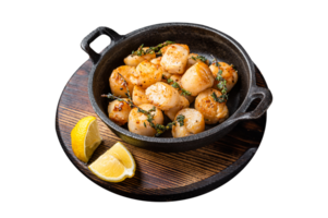 Scallops seared in garlic, thyme and butter served in cast iron skillet. Wooden background. Top view png