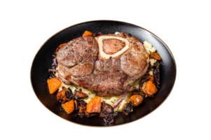 Osso buco cross cut veal shank with mashed potato on a plate. Dark background. Top view png