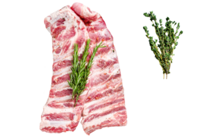 Rack of uncooked raw pork spare ribs seasoned with spices in a pan. Black background. Top view png