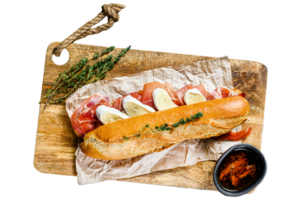 Baguette sandwich with prosciutto ham, Camembert cheese on a cutting Board. Black background, top view. png