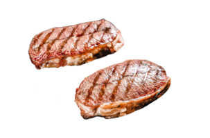 Grilled meat Top Blade steaks in a frying pan. Gray background. Top view png