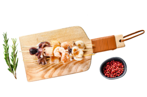Grilled shish kebab with seafood, shrimp, octopus, squid and mussels. Gray background. Top view. Space for text png