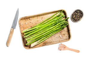 Raw young green asparagus in a wooden bowl. White background. Top view png