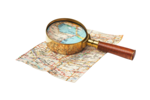 A magnifying glass rests on a folded map, emphasizing details and locations within the cartographic representation. png