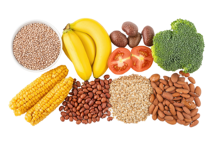 A variety of fresh produce including bananas, broccoli, corn, beans, and tomatoes arranged neatly in a colorful display. png