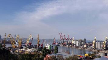 Port harbor with grain elevator terminal and container area. Pan right industrial sea view under windy clouds in high sky. Maritime port landscape in harbor of European Black sea coast video