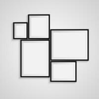 Four black frames on a wall with white background vector