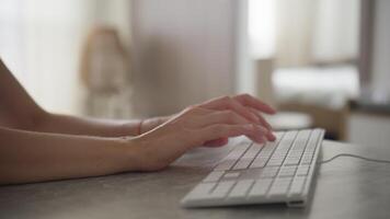 Hands Typing on White Keyboard in Soft-Lit Minimalist Workspace video