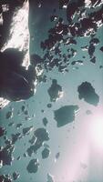 flying through the asteroid belt in outer space, vertical video