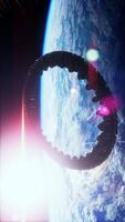 A mysterious spaceship orbits Earth, reflecting light as it hovers in space video