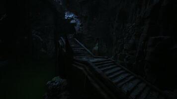 Mysterious stone staircase illuminated by soft light in dark cave environment video