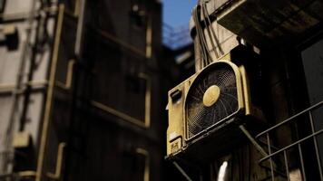 Old air conditioning unit mounted on a weathered building exterior video
